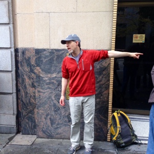 David B. Williams talks Seattle geology in front of the Exchange Building's 3.54 billion-year-old gneiss feature. 